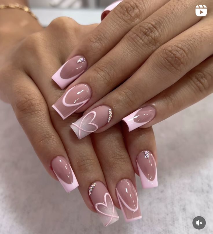 Romantic Nude and Soft Pink Nail Design with Glossy Finishes and Heart Patterns