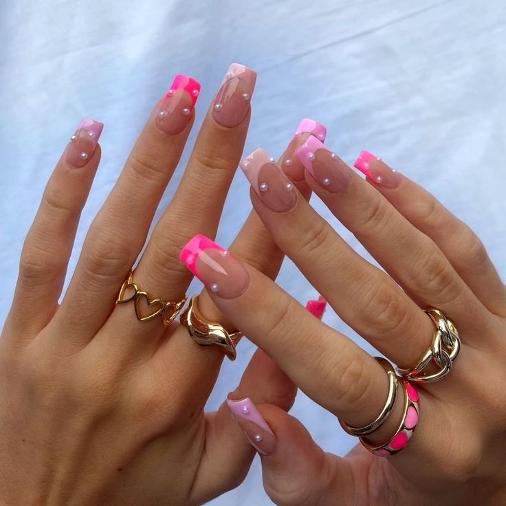 Playful Pink and Nude Nail Design with Bold Neon Accents and Elegant Embellishments