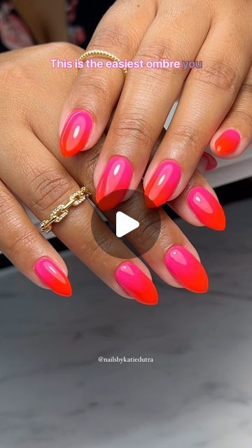 Bold Ombre Nail Design in Pink and Orange with Stiletto Tips and Gold Accessories.