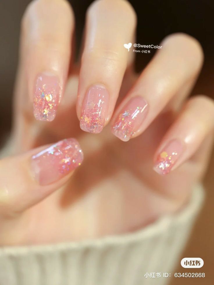 Pastel Pink and Iridescent Glitter Nail Design: Enchanting and Glamorous Manicure.