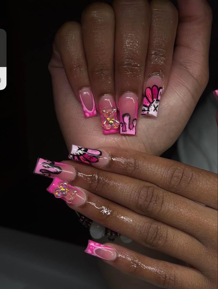 Bold and Playful Pink and Clear Acrylic Nail Design with Artistic Patterns and Colorful Gems.