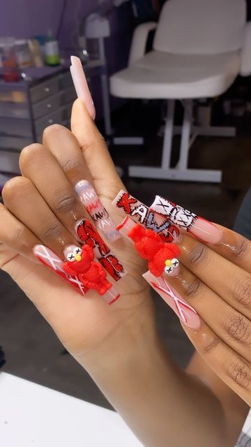 Playful Whimsical Nail Design with Vibrant Red Accents and Unique Textures.