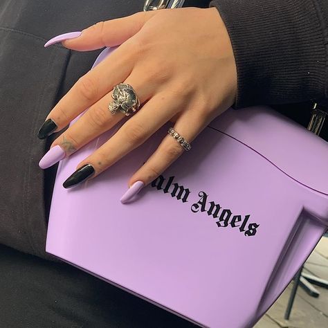 Chic Almond-Shaped Nail Design in Matte Black and Pastel Lavender with Edgy Statement Ring.