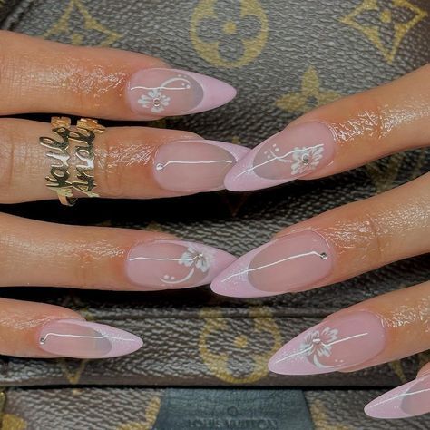 Chic Elegant Almond-Shaped Nails with Soft Pink Base and Delicate White Floral Designs.