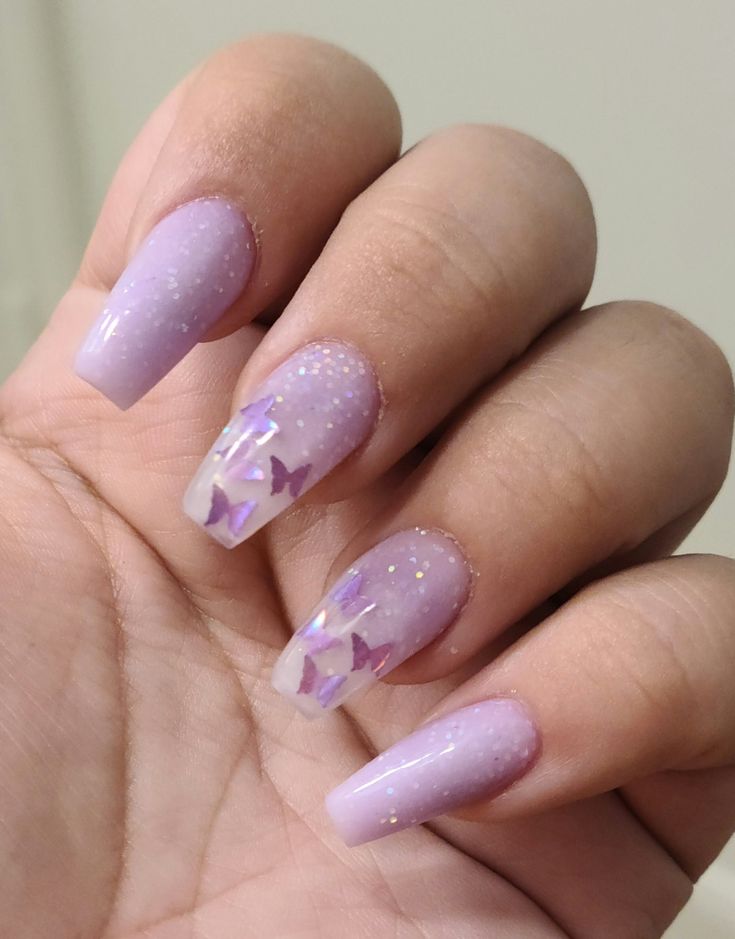 Elegant Lavender Gradient Nails with Glitter and Butterfly Accents for Spring.