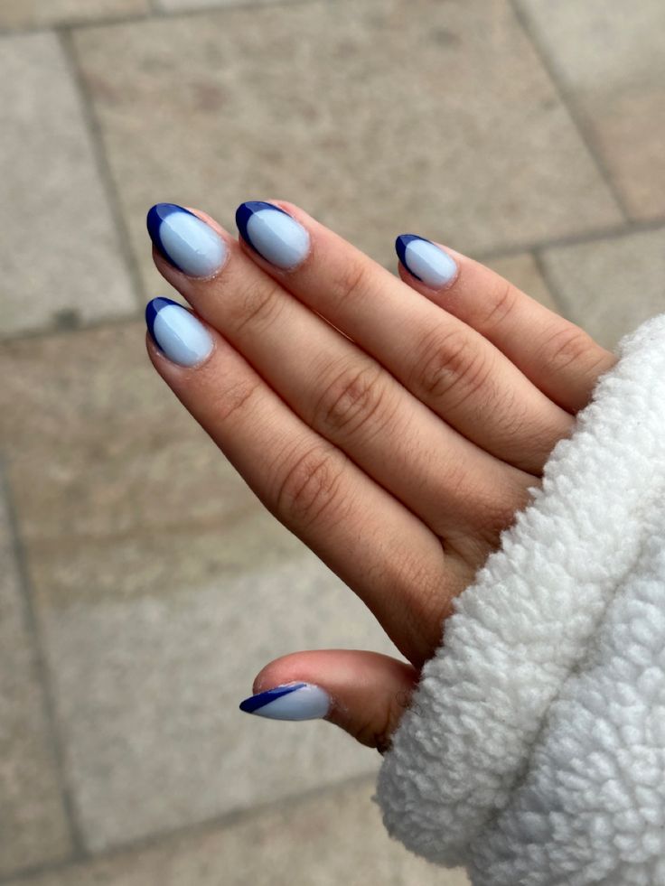 Chic Pastel Blue Nails with Navy Tips for a Sophisticated Look.