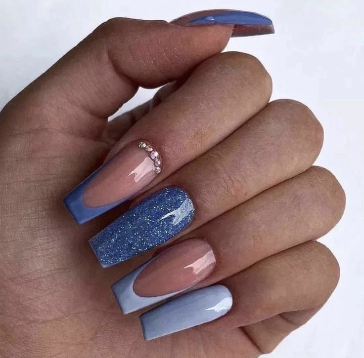 Chic Ombre Blue Nail Design with Glitter Accents and Elegant Rhinestone Embellishments.