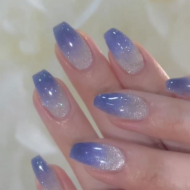 Elegant Ombre Nail Design: Deep Blue to Soft Lavender with Shimmering Silver Tips.