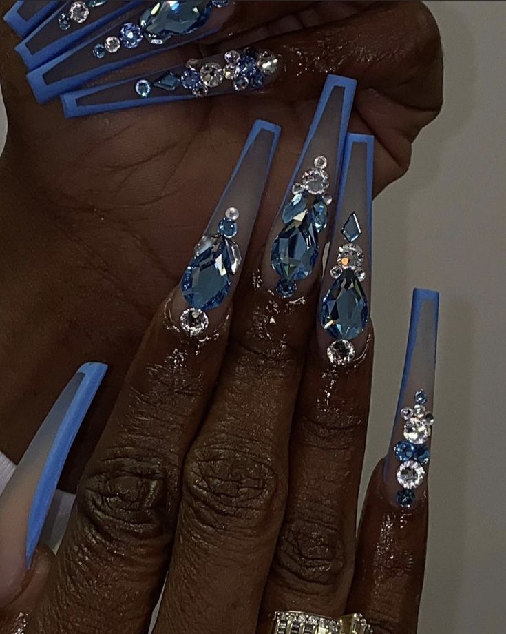 Striking Blue Elongated Nail Design with Rhinestones for Artistic Elegance.