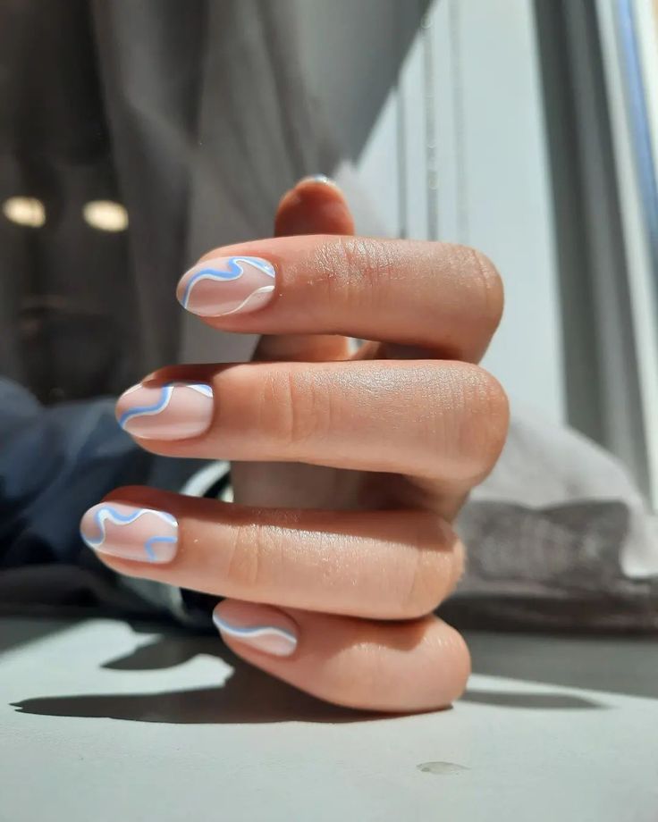 Sophisticated Minimalist Nail Design: Soft Nude Base with Delicate Blue Swirls