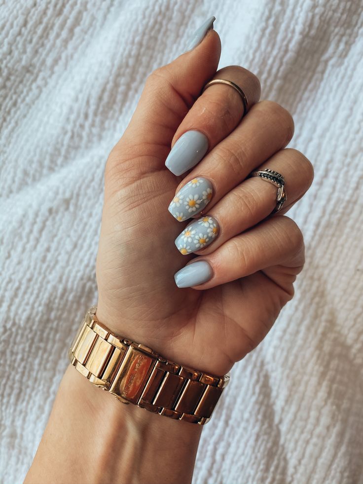 Serene Soft Blue Nail Design with Charming Floral Accents for Versatile Elegance.