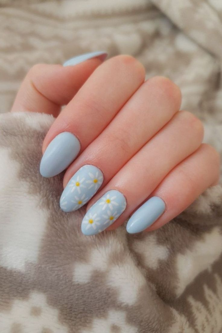 Chic Pastel Blue Almond Nails with Floral Accents.