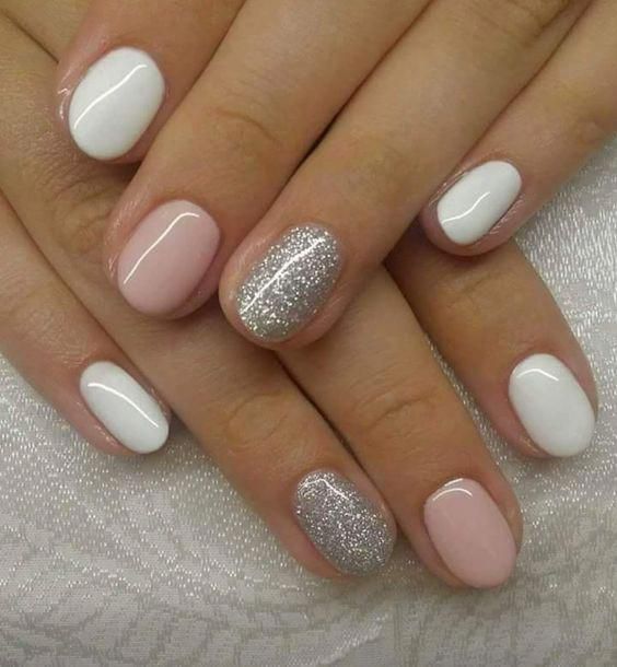 Chic Elegant Nail Design: Soft Pink and White with Glittery Silver Accent.