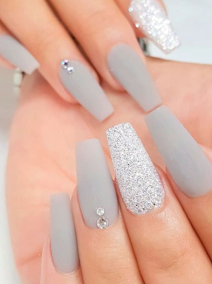 Elegant Matte Gray Nails with Shimmering Silver Accents and Glitter Overlay.