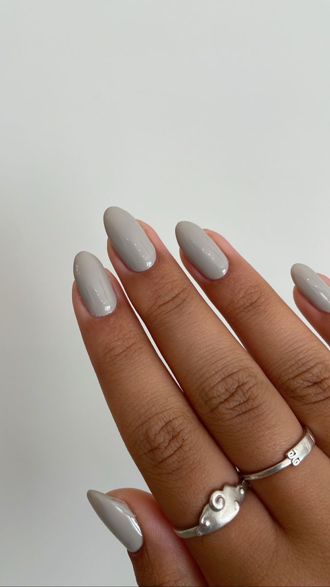 Elegant Soft Gray Almond-Shaped Nails Paired with Delicate Silver Rings.