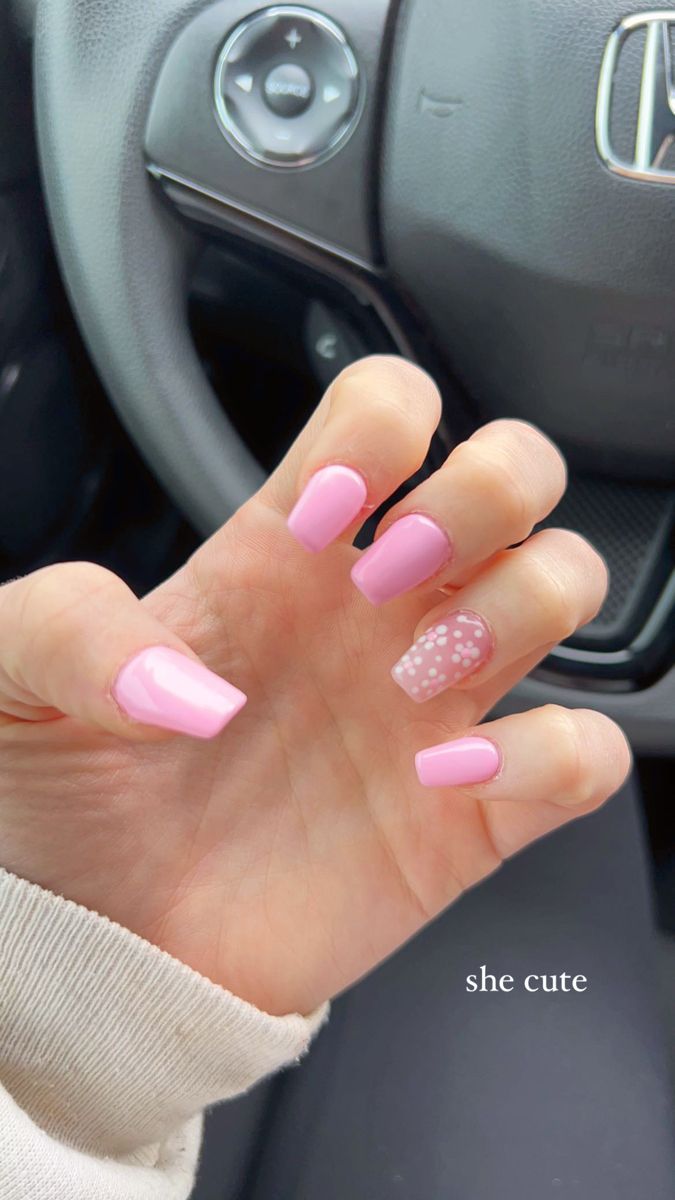 Playful Pastel Pink Nails with Polka Dot Accent: A Stylish Trend for Any Occasion.