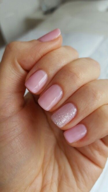 Chic Pastel Nail Design: Soft Pink Base with Subtle Glitter Accent for a Sophisticated Look.