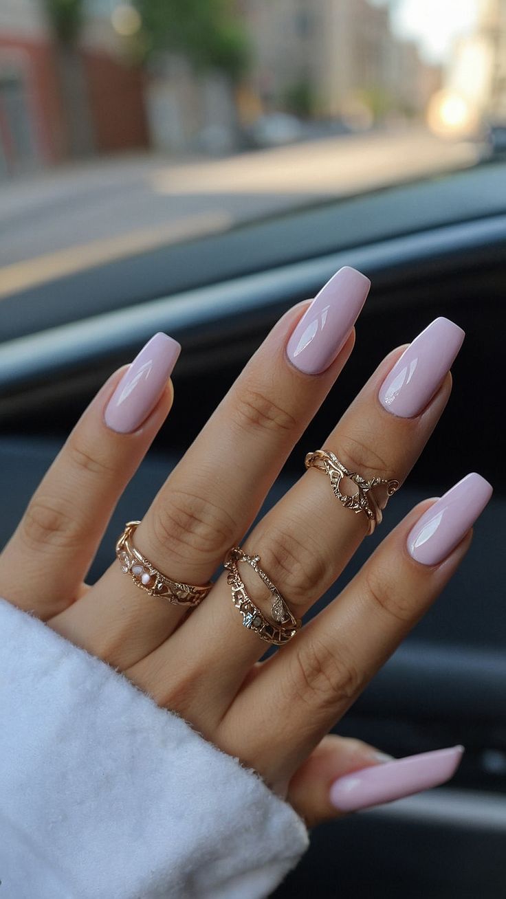 Chic Pastel Pink Square Nails with Glossy Finish and Gold Accents for a Sophisticated Look.