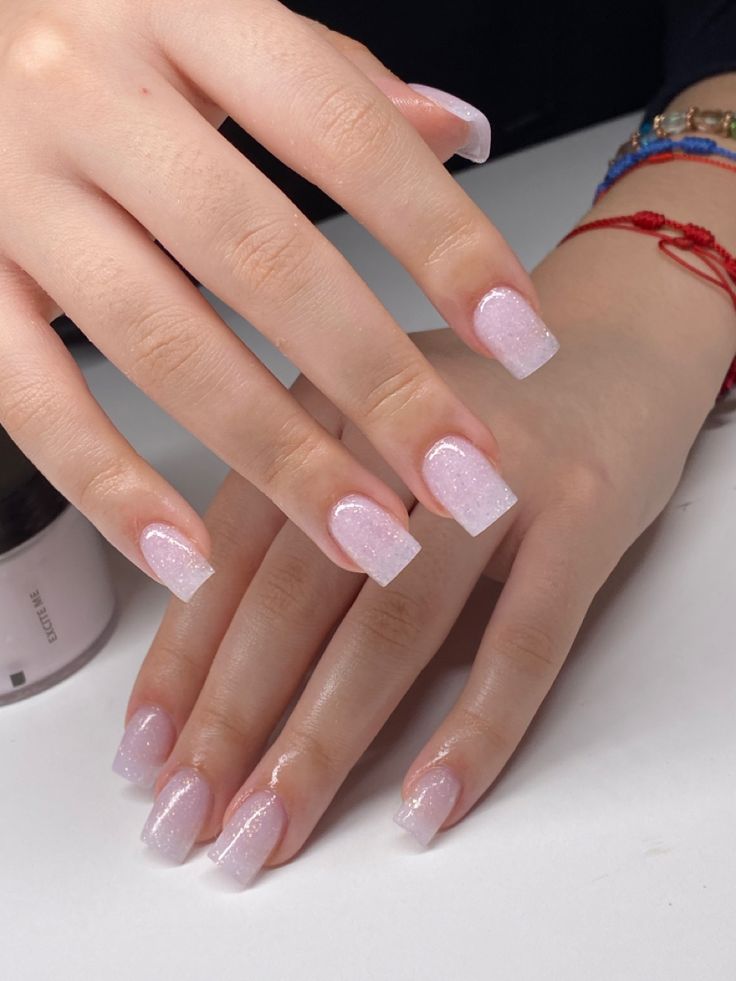 Sophisticated Soft Pink Gradient Nail Design with Subtle Glitter Elegance.