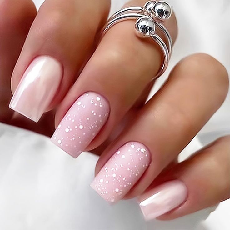 Elegant Pale Pink Gradient Nail Design with Glossy Finish and Sparkling Glitter Accents