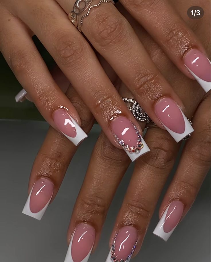 Chic French Tip Nail Design with Soft Pink Base and Crystal Accents