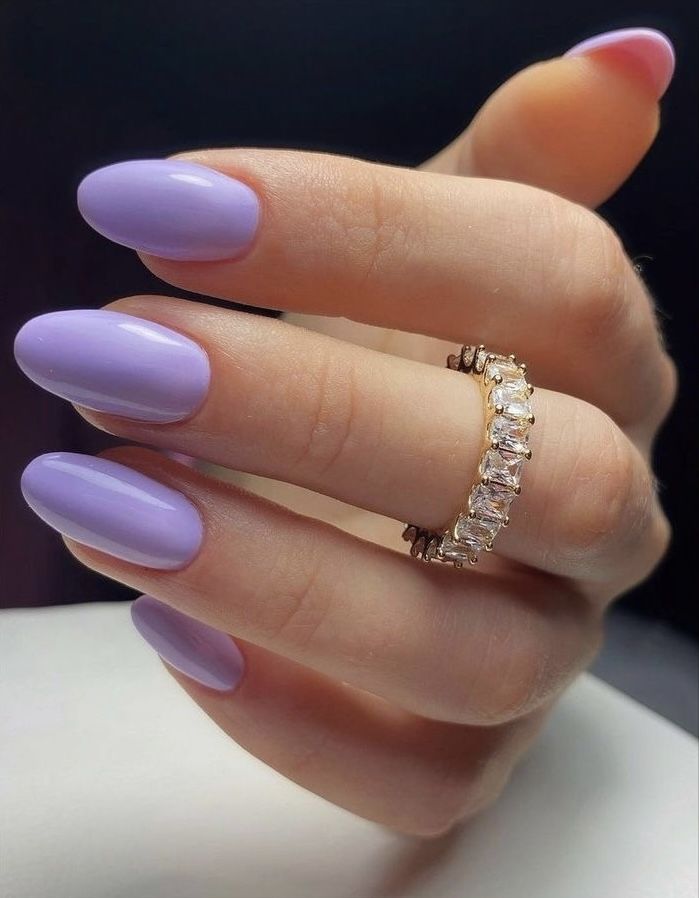 Elegant Lavender Almond Nail Design with Glossy Finish and Sparkling Ring