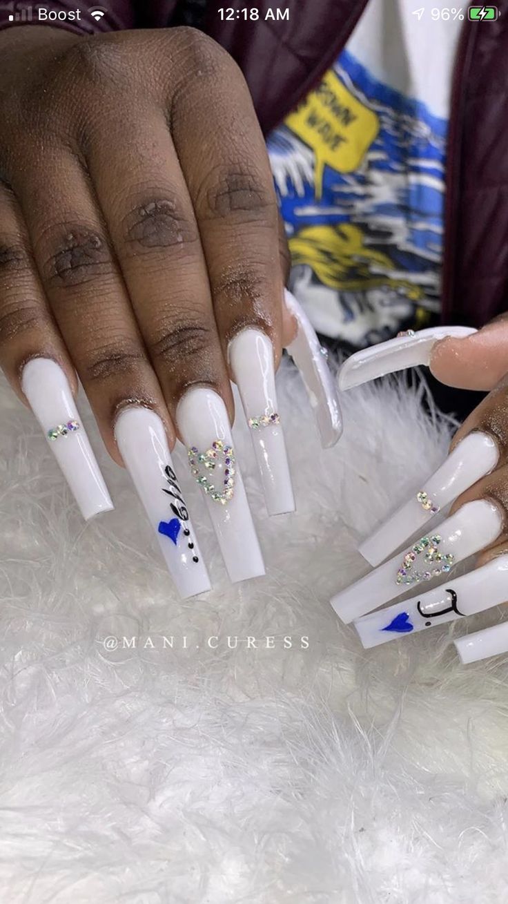 Elegant White Acrylic Nails with Colorful Rhinestones and Heart Accents.