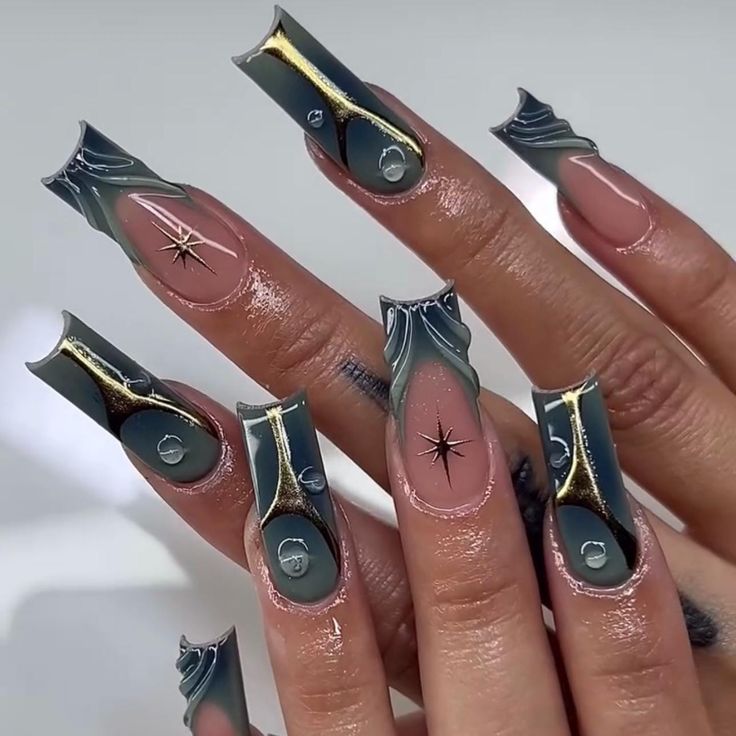 Futuristic Abstract Nail Design with Glossy Black, Gray, and Nude Hues Accented by Metallic Details and Star Motif.