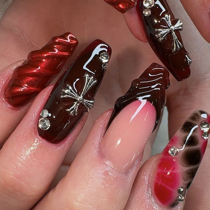 Eye-Catching Deep Red and Brown Nail Design with Metallic Accents and Textured Finishes