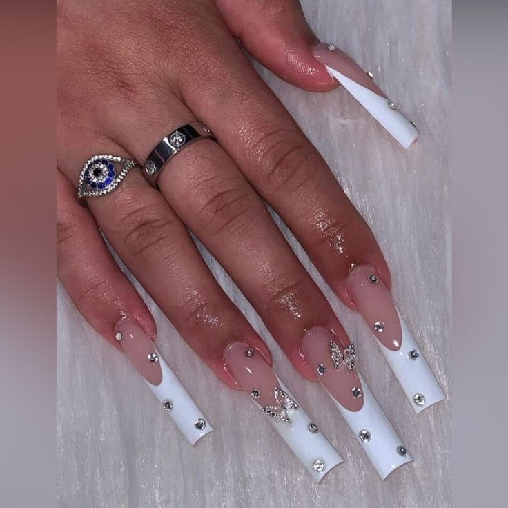 Chic Nude and White Nail Design with Rhinestones and Pointed Shape for an Elegant Statement.