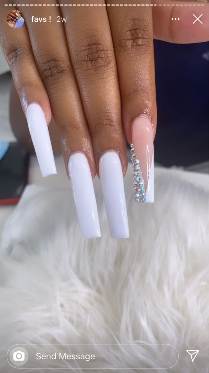 Sophisticated Elegant Nail Design: Glossy White with Chic Nude and Sparkling Rhinestones.