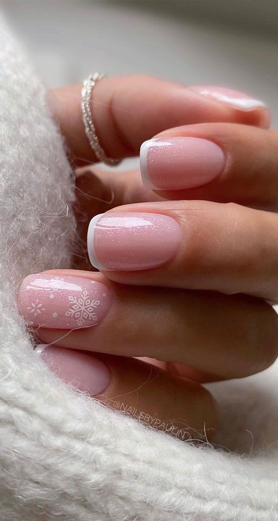 Charming Winter-Inspired French Manicure with Soft Pink Base and Snowflake Accents