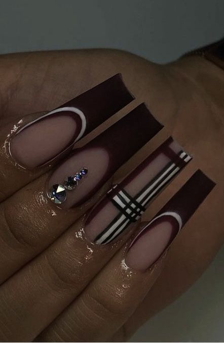 Chic Burgundy Nail Design with Geometric Patterns and Sparkling Accents.