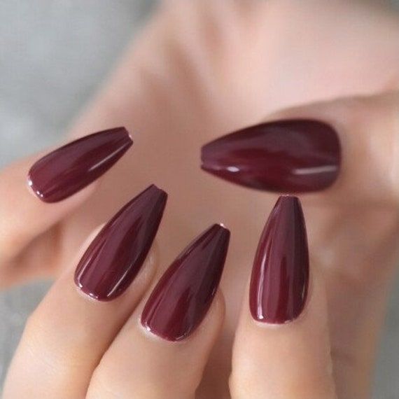 Sophisticated Burgundy Almond Nails with Glossy Finish for Any Occasion.