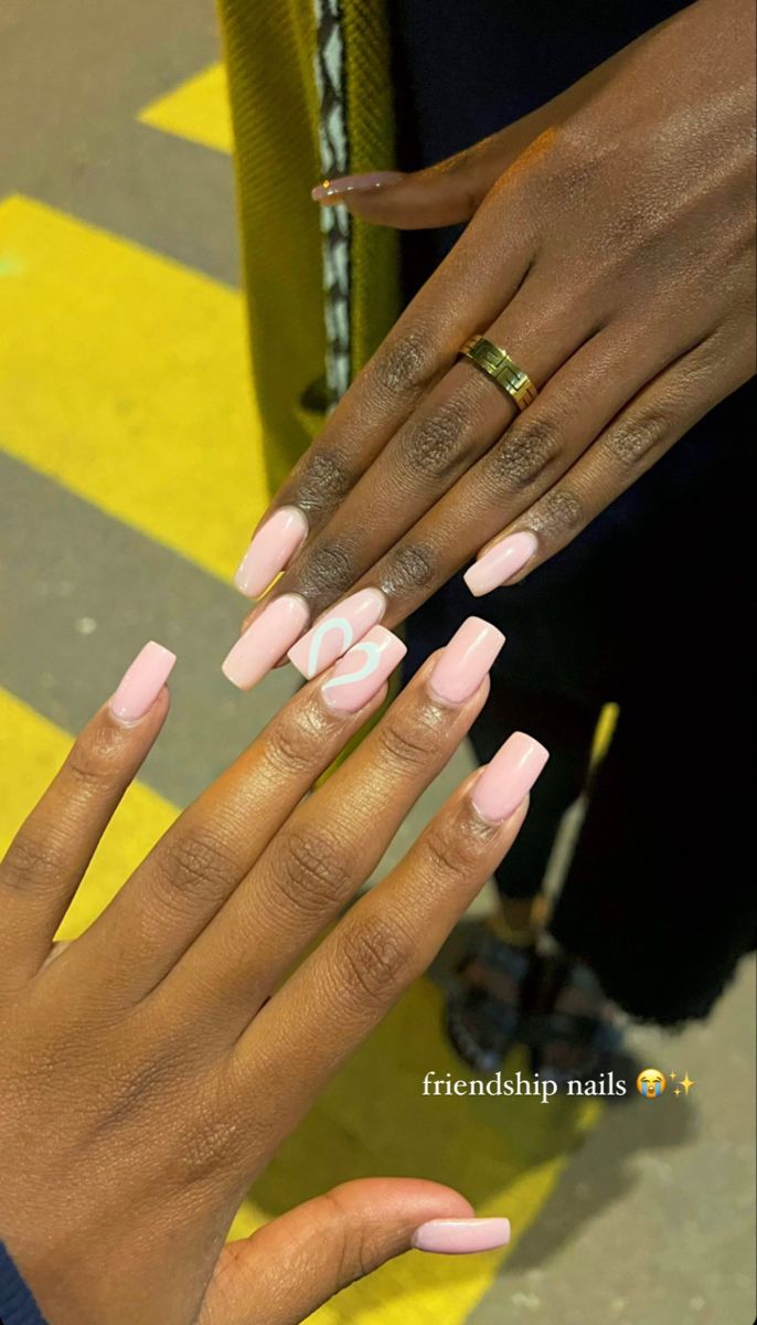 Chic Friendship Nails: Soft Pink Base with Heart Design for a Stylish Connection.