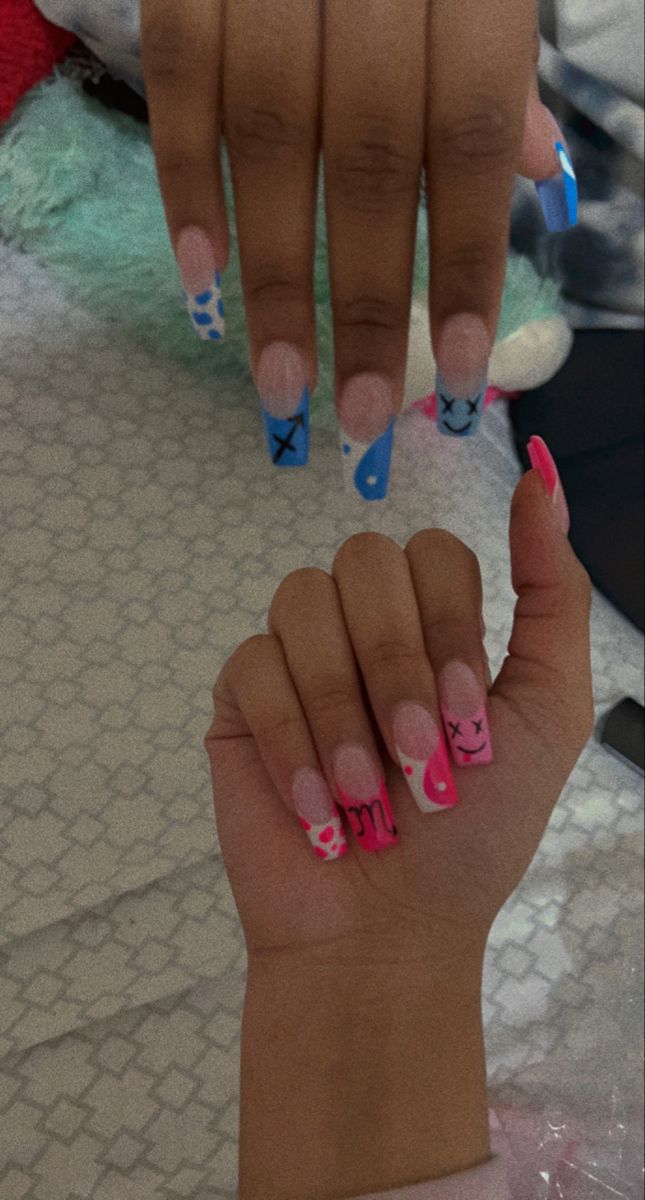 Trendy Pastel Blue and Pink Nail Designs with Playful Patterns.