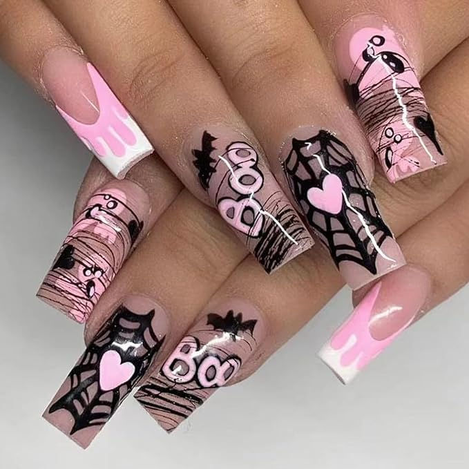 Playful and Spooky Halloween Nail Art: Intricate Spider Webs and Bats on Soft Pink with Whimsical Hearts.