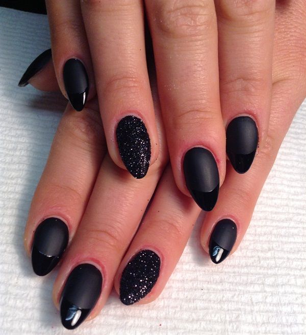 Sophisticated Black Nail Design with Matte and Glossy Finishes Accented by Sparkling Glitter.