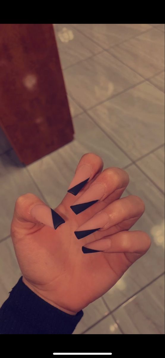 Bold Geometric Nail Design with Sharp Black Triangles for Edgy Individuality.