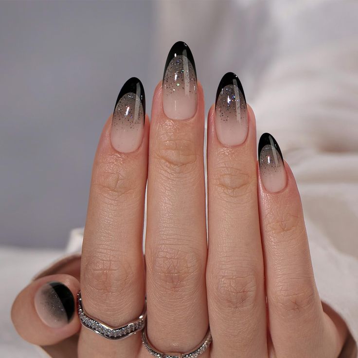 Chic Ombre Nail Design: Sophisticated Gradient of Soft Nude to Black Tips with a Touch of Glamour.