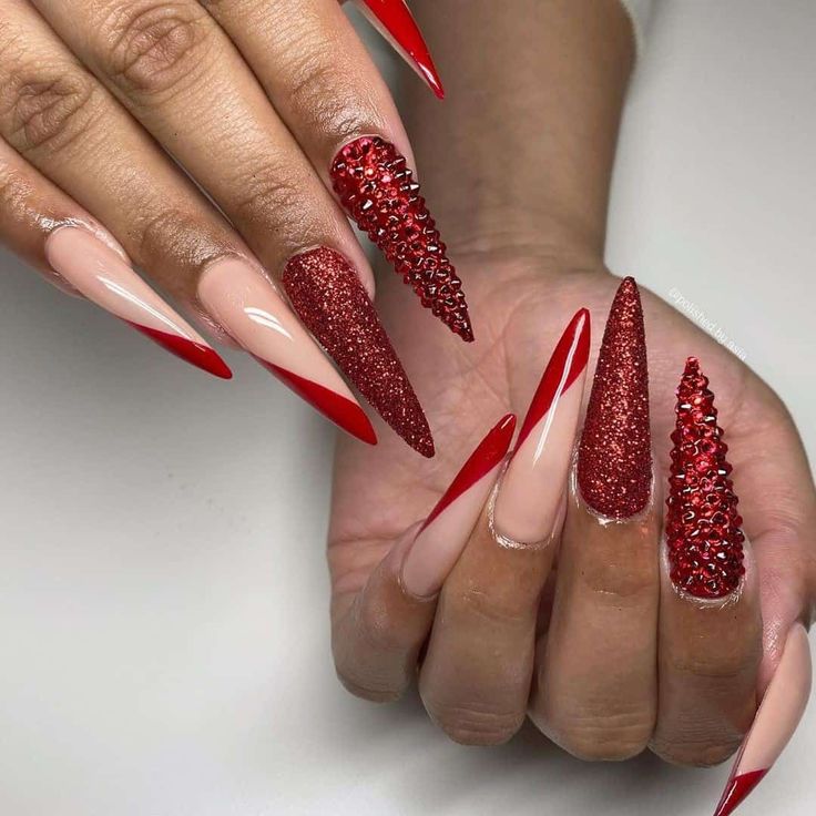 Bold Red and Nude Nail Design with Glamorous Rhinestone Accents.