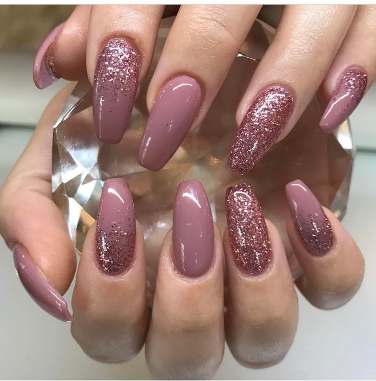 Elegant Almond-Shaped Nails with Dusty Rose Polish and Glamorous Glitter Accents.