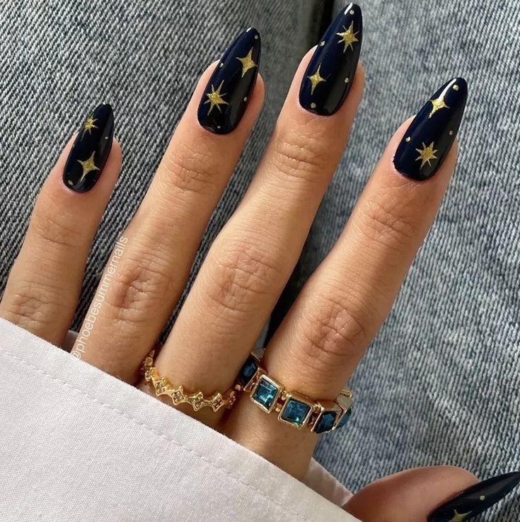 Celestial Elegance: Starry Night Nail Design with Gold Accents and Sophisticated Rings