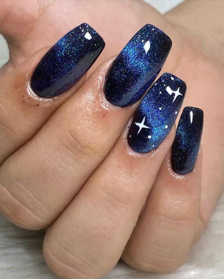 Cosmic Elegance: Galaxy-Inspired Nail Design with Deep Blues and Shimmering Glitter