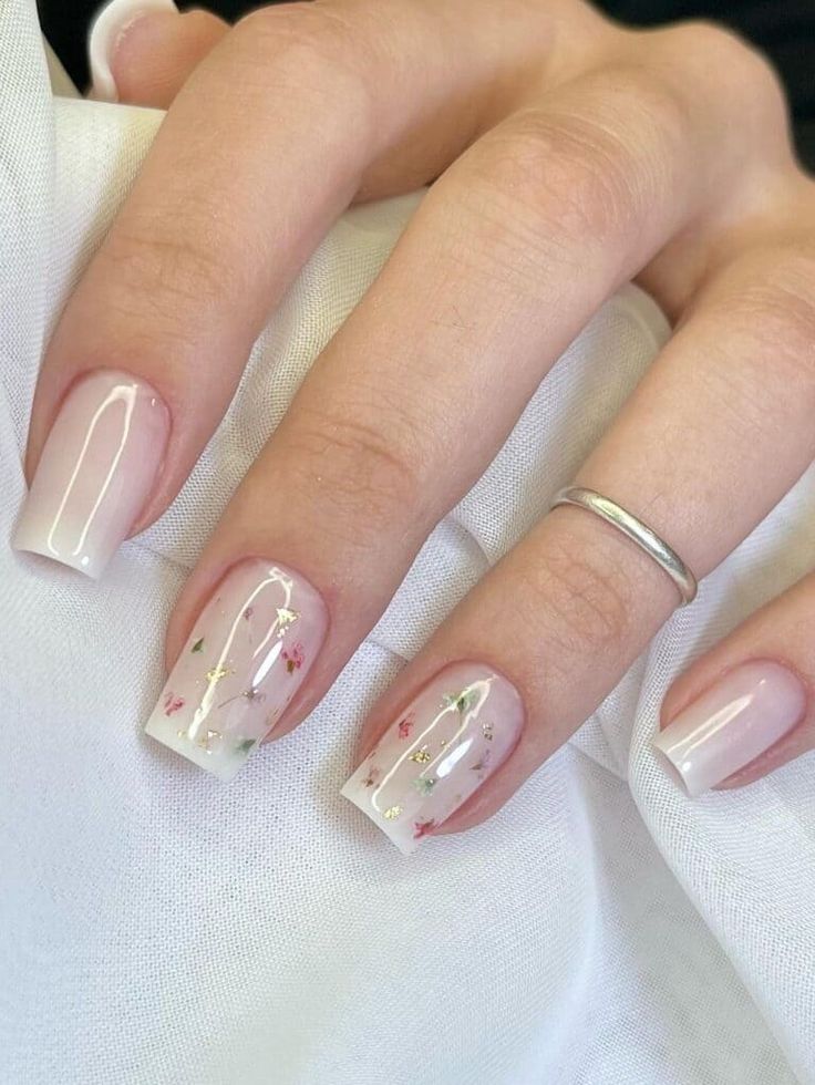 Elegant Soft Pink Nail Design with Floral Accents in Red and Gold Shimmer