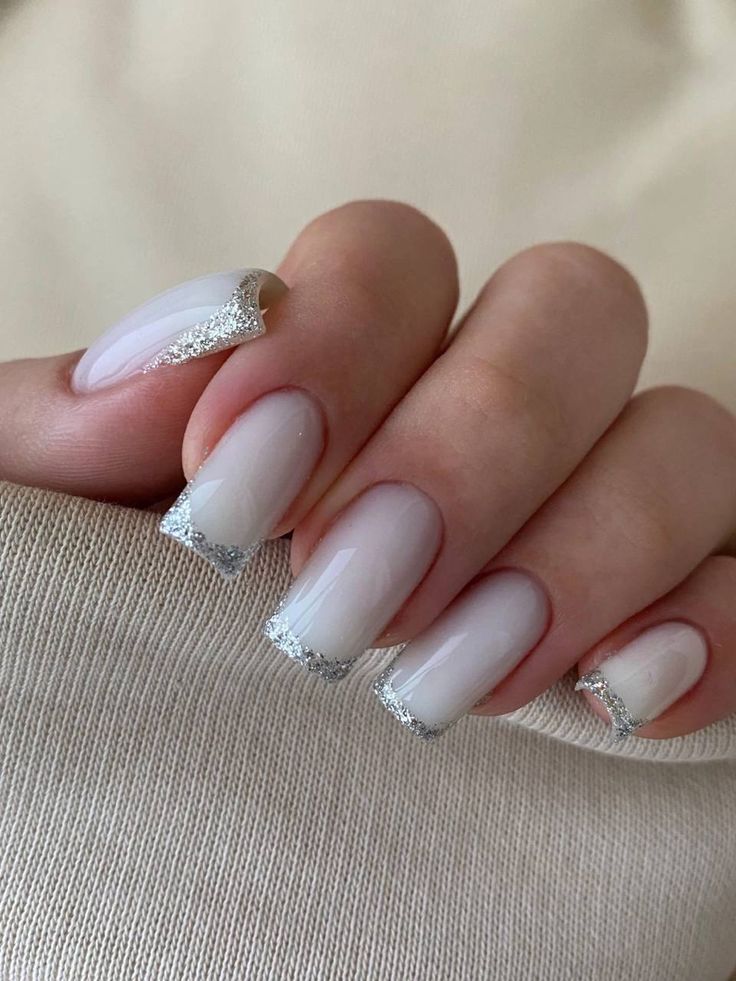 Sophisticated Nude Nails with Silver Glitter Tips for a Modern Look.