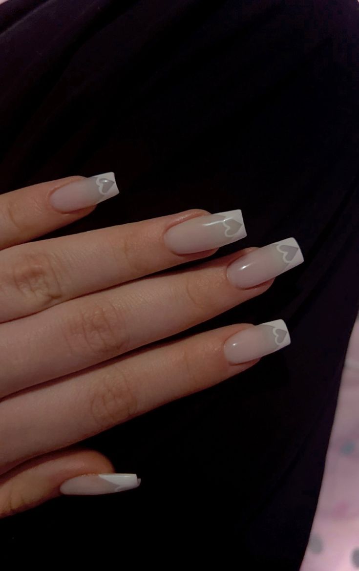 Chic Nude Nail Design with Heart-Accented White Tips for a Romantic Touch