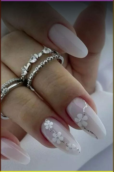 Sophisticated Floral Nail Design with Soft White Base and Silver Accents.