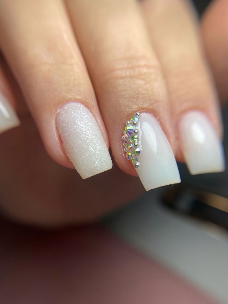 Elegant White Gradient Nail Design with Glamorous Sparkling Accents.