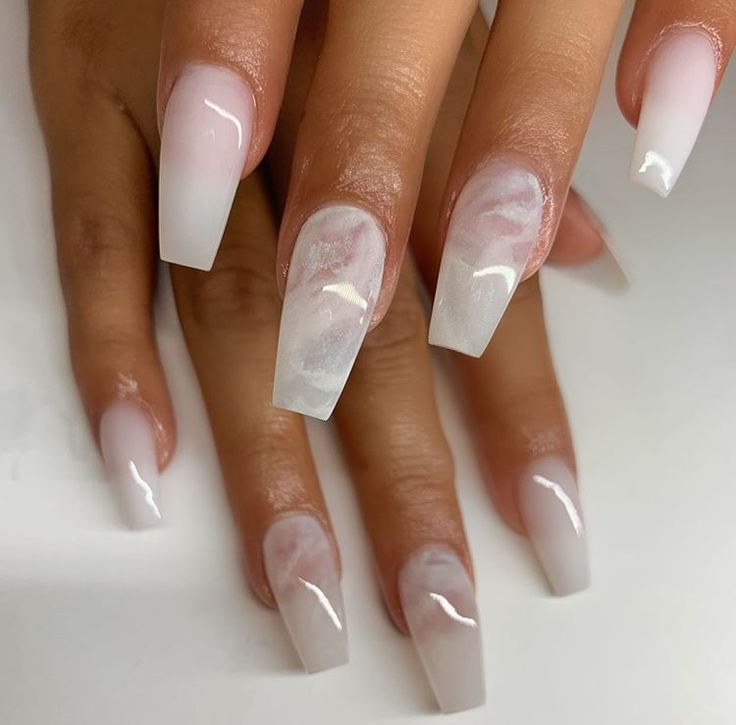 Chic Ombre Nail Art: Milky White Base with Sheer Pink Tips and Marbled Accent.